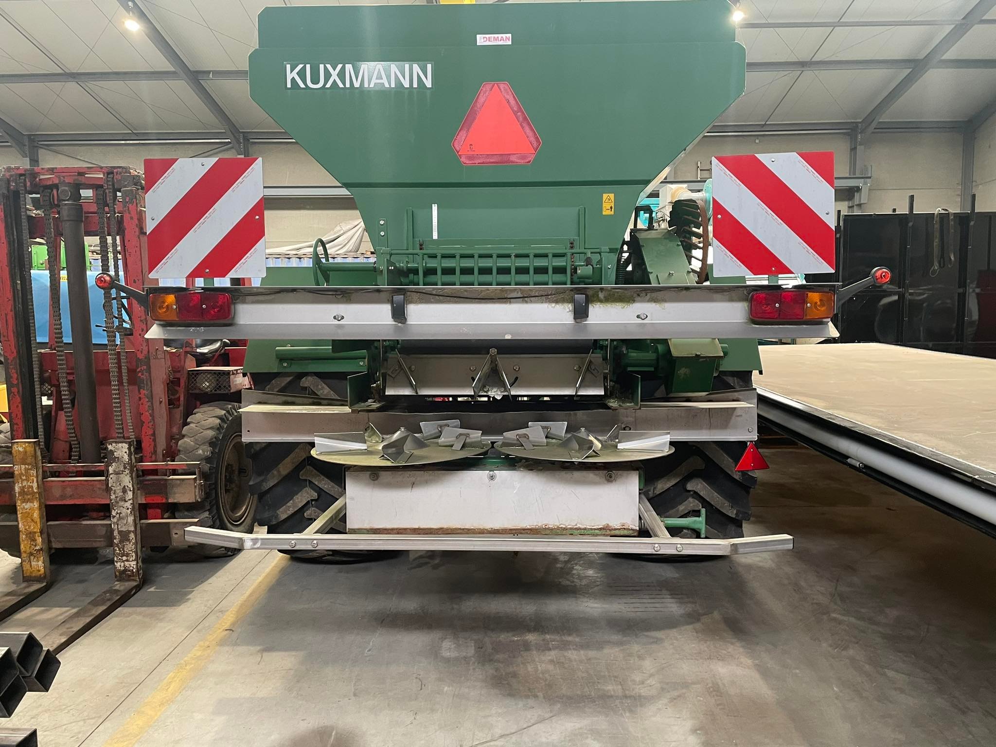 Rear of a green Kuxmann lime spreader with signalling