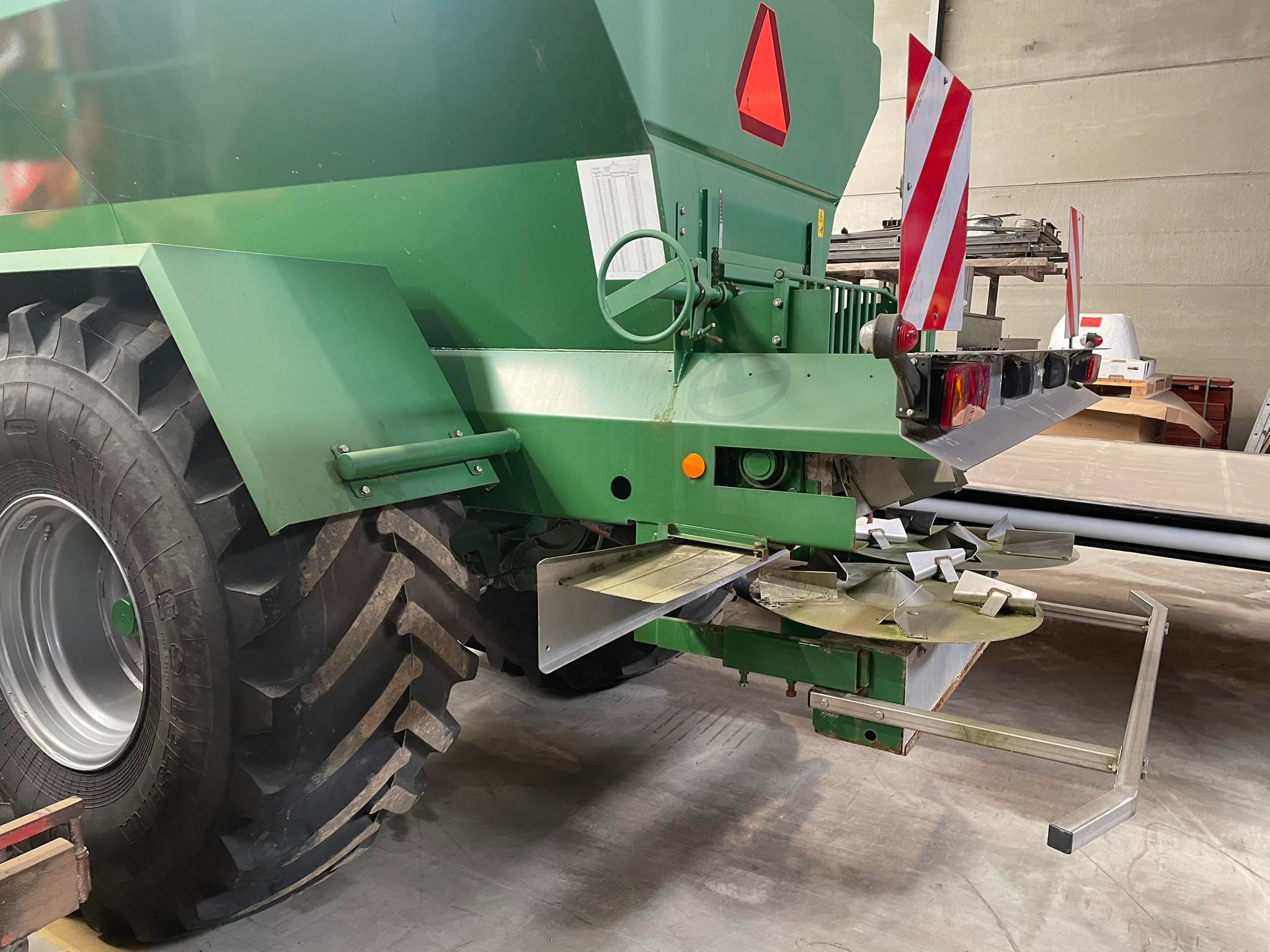 Rear view of a green Kuxmann lime spreader.