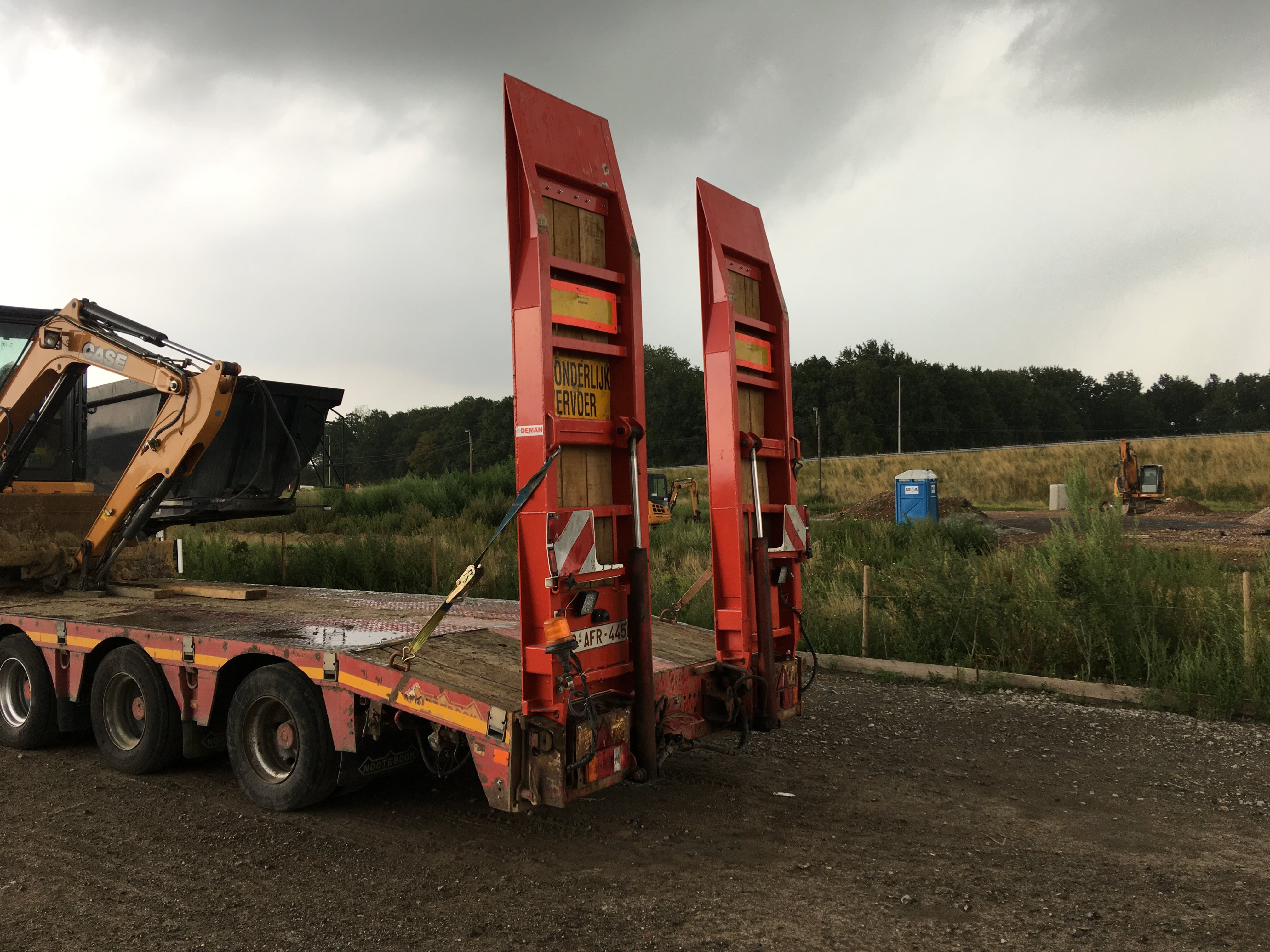 low loader - vehicle transport trailer with crane on deck - on-site operations