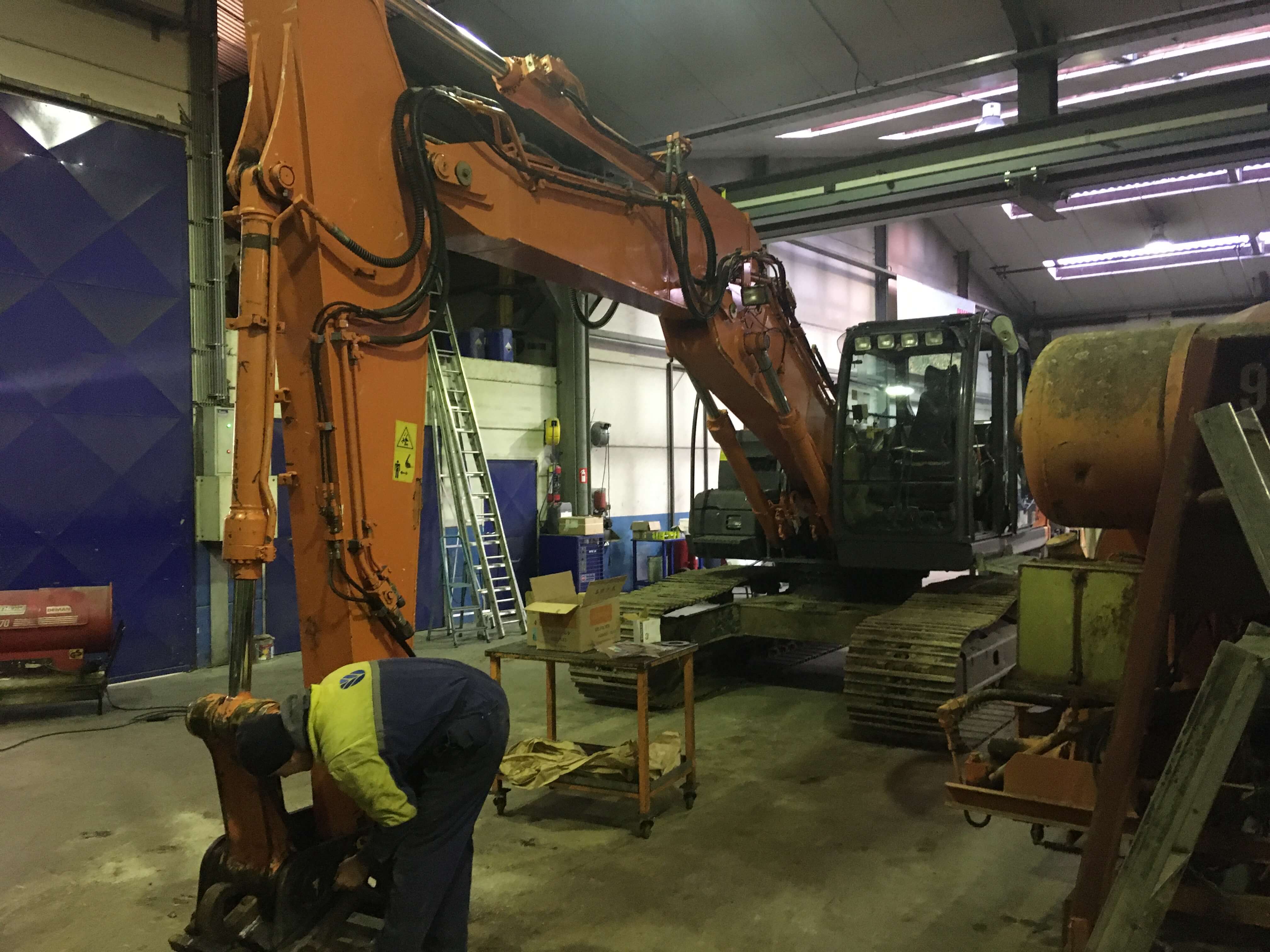 photo repair depot - mechanic works on crane